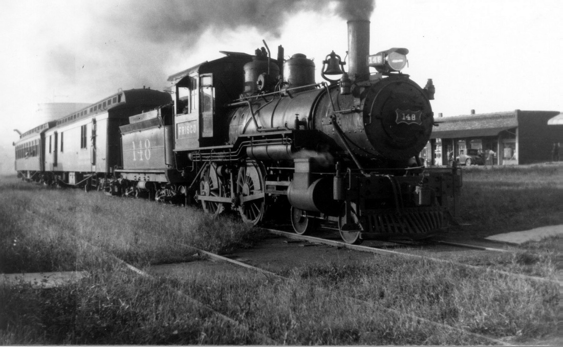 Frisco steam locomotive number 148, in front of general store.